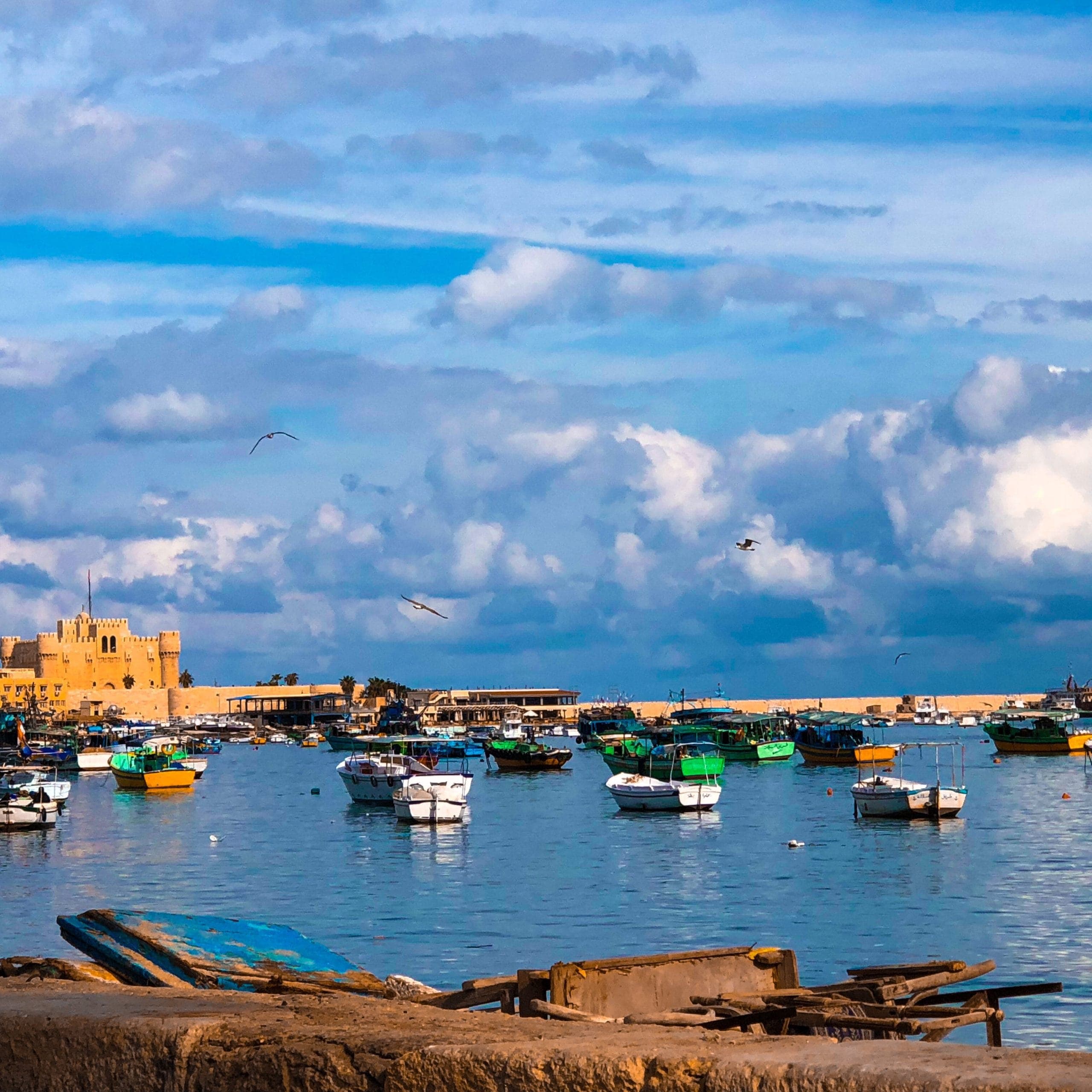 boats-moored-sea-against-sky-city